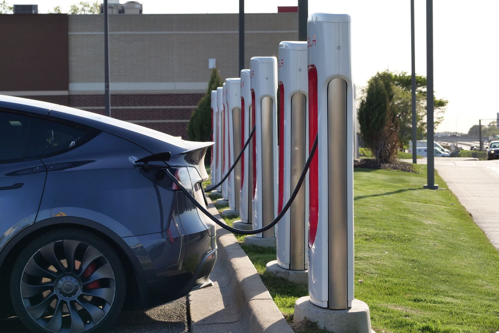Electric car plugged into a row of chargers